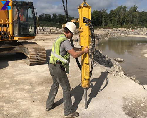 rock drill and splitter attachments mounted on excavators